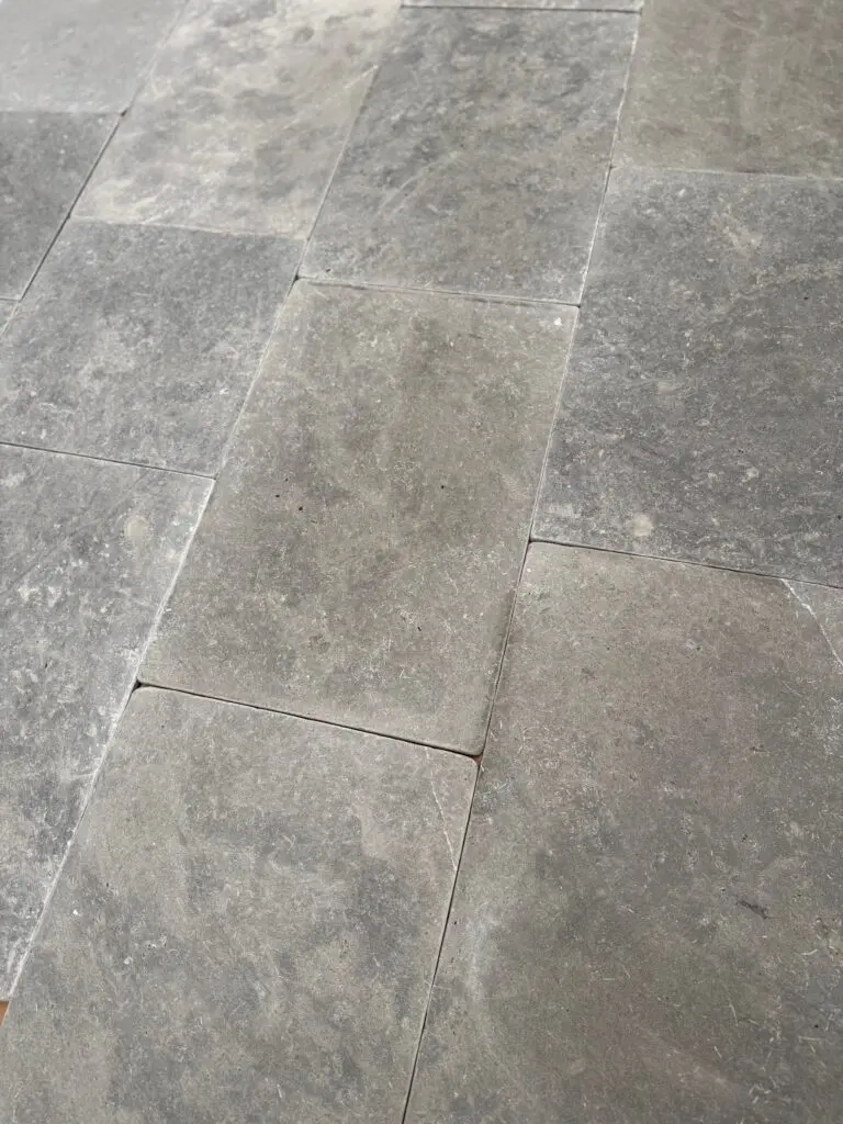 grått tumlat kalkstensgolv i blandade storlekar