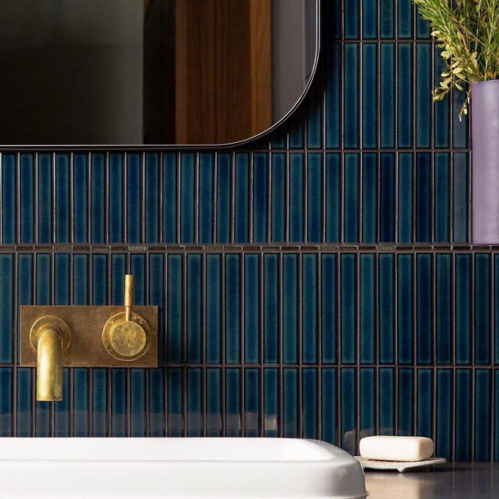 bathroom sink with a backsplash of blue japanese ceramic tiles