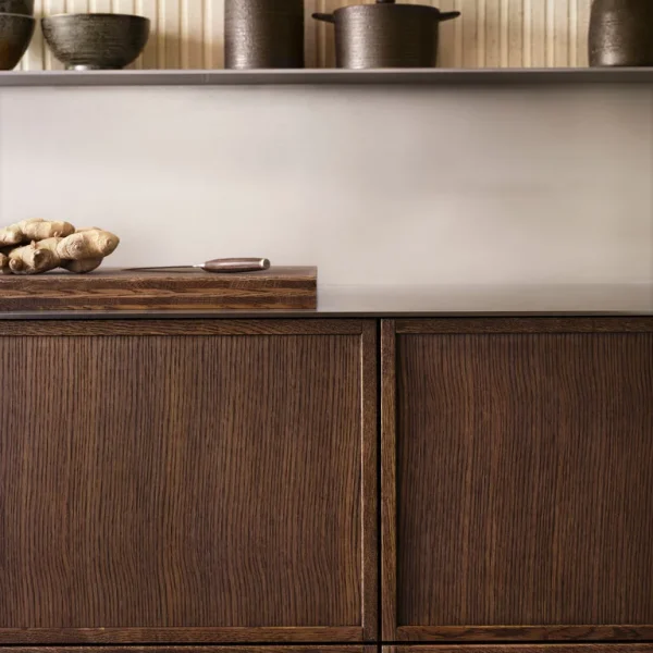 modernt japandi kök med mörka träluckor och avlångt vitt kakel