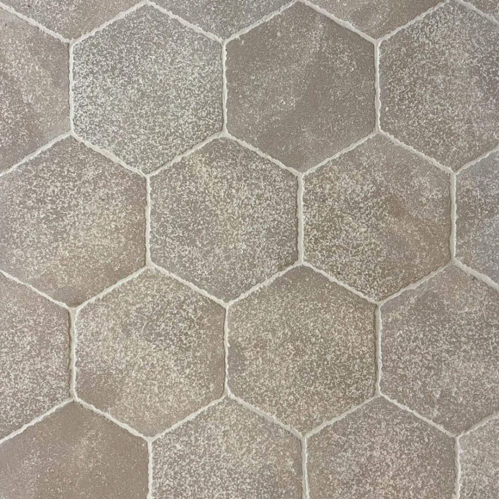 beige antikbehandlad kalksten på golv i hexagoner